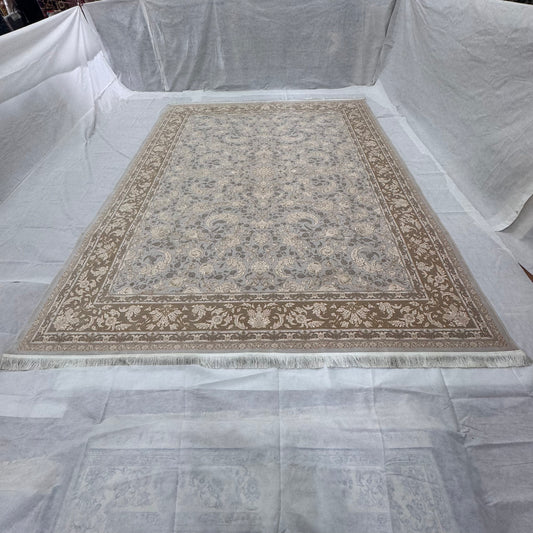 Decorative rug on a white floor with a white sheet covering the walls
