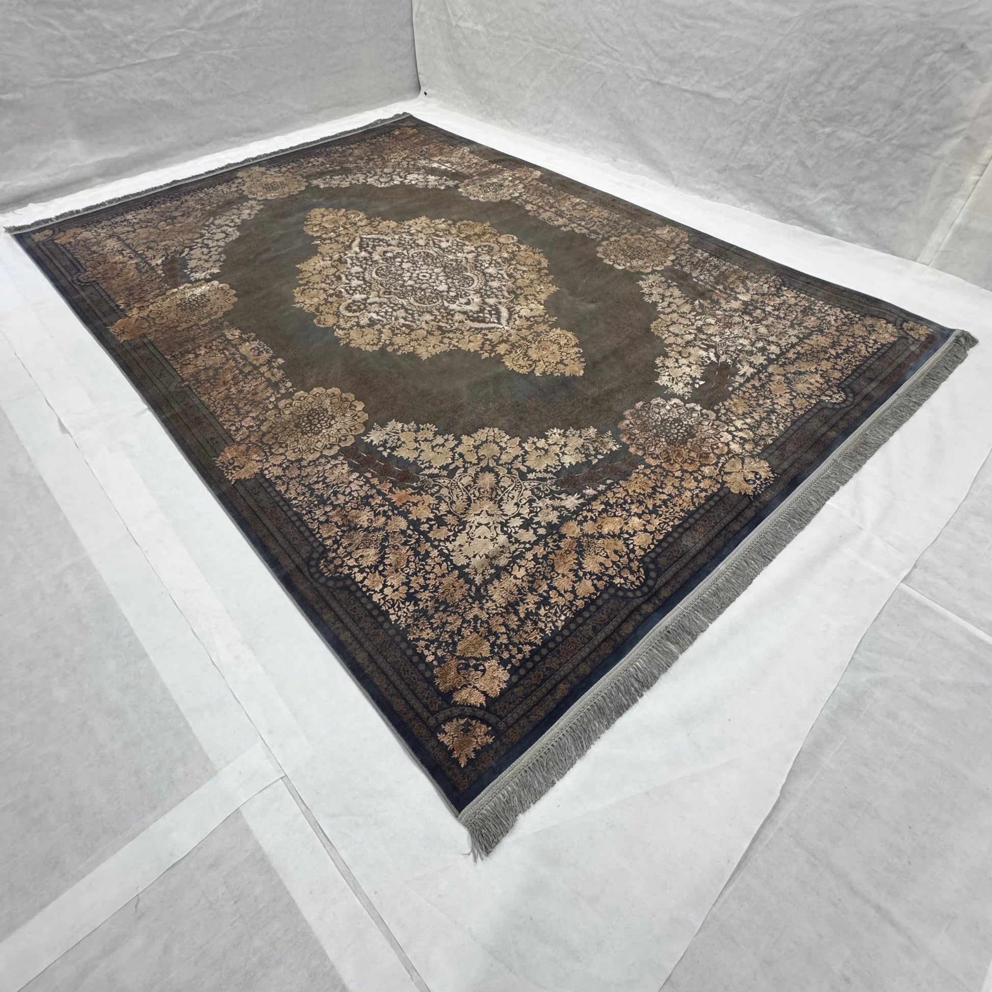 An 8 ft x 11 ft Persian Beheshti Tabriz Rug with a floral blue design, featuring intricate patterns and a central medallion, displayed on a white background.